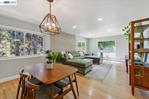 a living room with furniture lamp and window