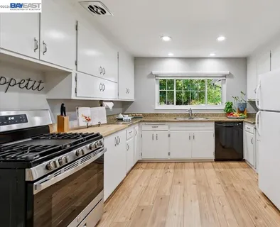 a kitchen with granite countertop a sink and a window