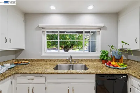 a white refrigerator freezer and a stove sitting inside of a kitchen