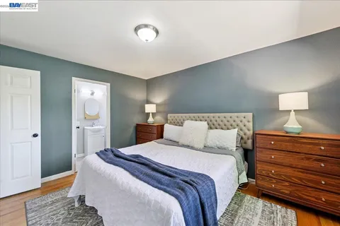 a bedroom with a bed and a mirror