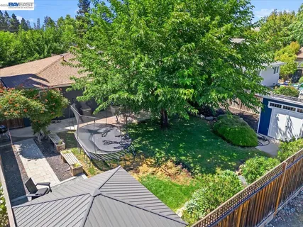 a backyard of a house with table and chairs