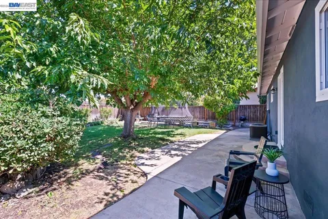 a view of a house with backyard and sitting area