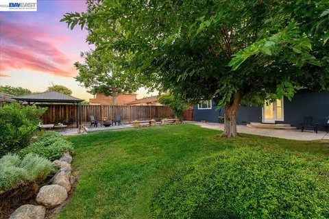 a view of a backyard with sitting area furniture and garden