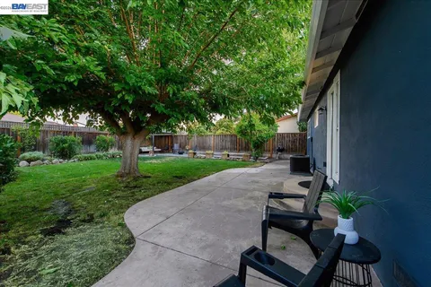 a view of a house with backyard and a slide