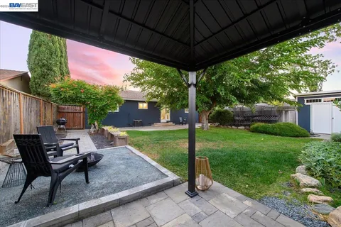 a view of patio with a table and chairs
