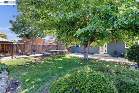 a view of yard with swimming pool and sitting area