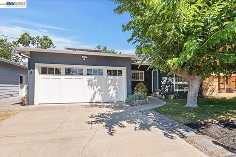 a front view of a house with a yard and a garage