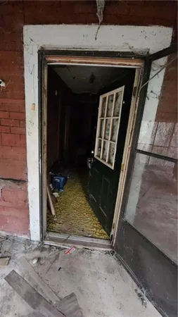 a utility room with dryer washer and a view of living room