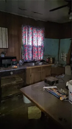 a view of backyard with a table and chairs