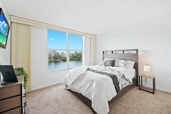 a bedroom with a bed and a lamp