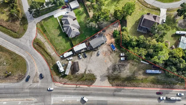 an aerial view of a house with a yard and garden