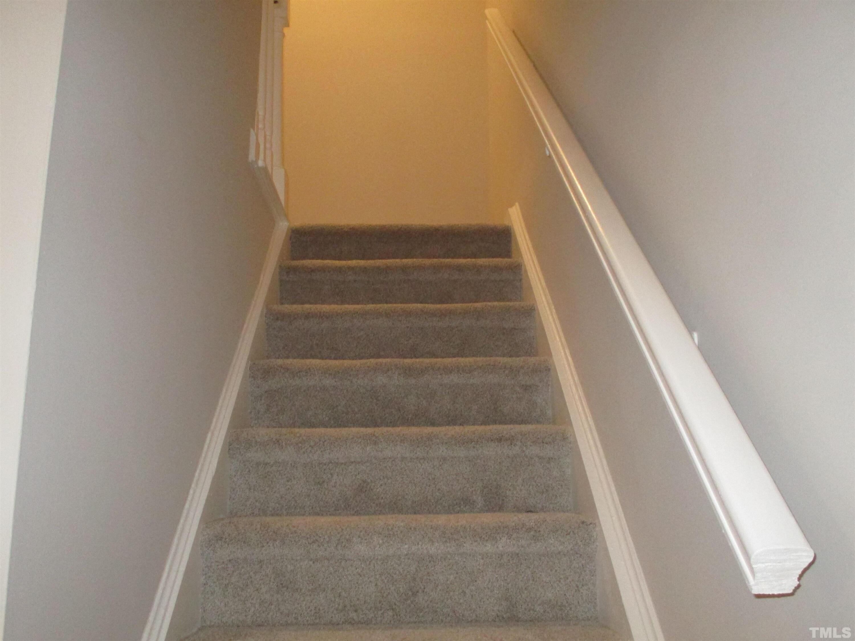 6435 New Market Way Raleigh, NC 27615 - Photo 7 of 17 a view of staircase with white walls