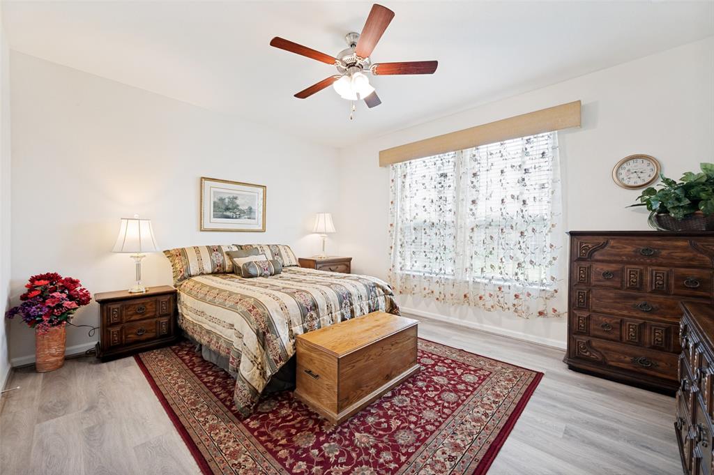 413 Wiggins Way Van Alstyne, TX 75495 - Photo 14 of 25 Bedroom featuring light wood-finish flooring, a ceiling fan with integrated lighting, and a window with blinds