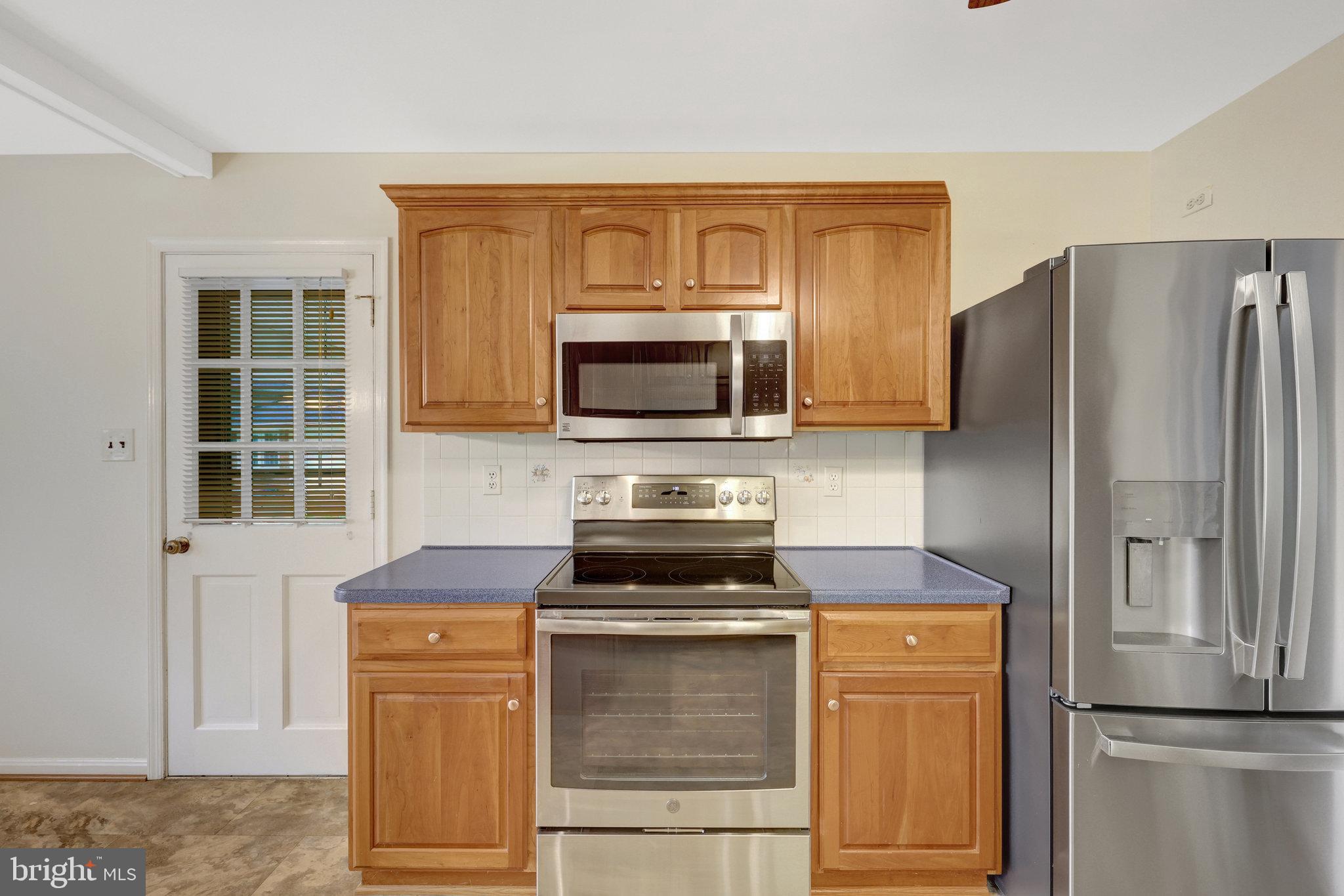 615 Kearney Court Southwest Vienna, VA 22180 - Photo 12 of 53 a kitchen with stainless steel appliances granite countertop a refrigerator stove and microwave