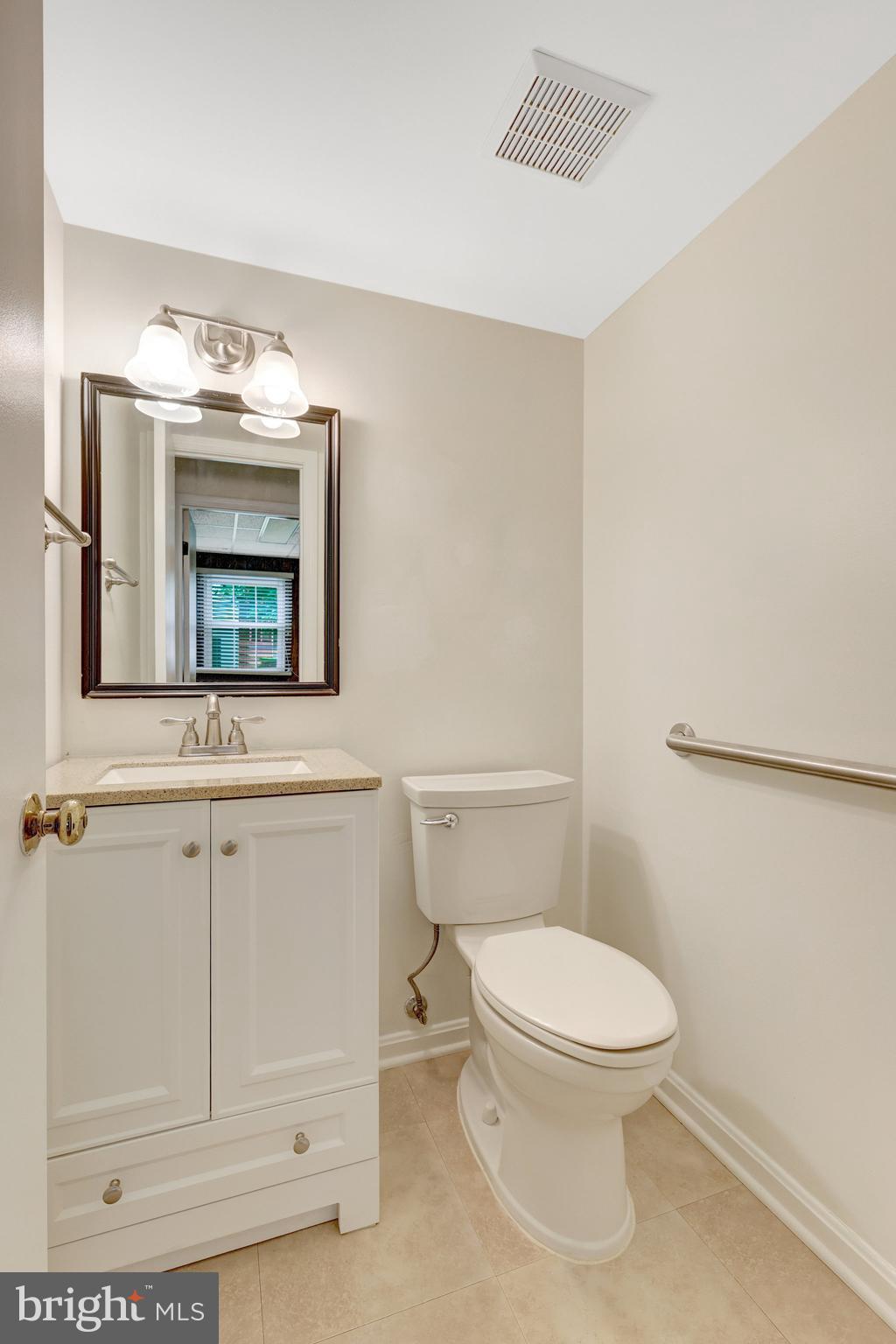 615 Kearney Court Southwest Vienna, VA 22180 - Photo 20 of 53 a bathroom with a toilet a sink and mirror