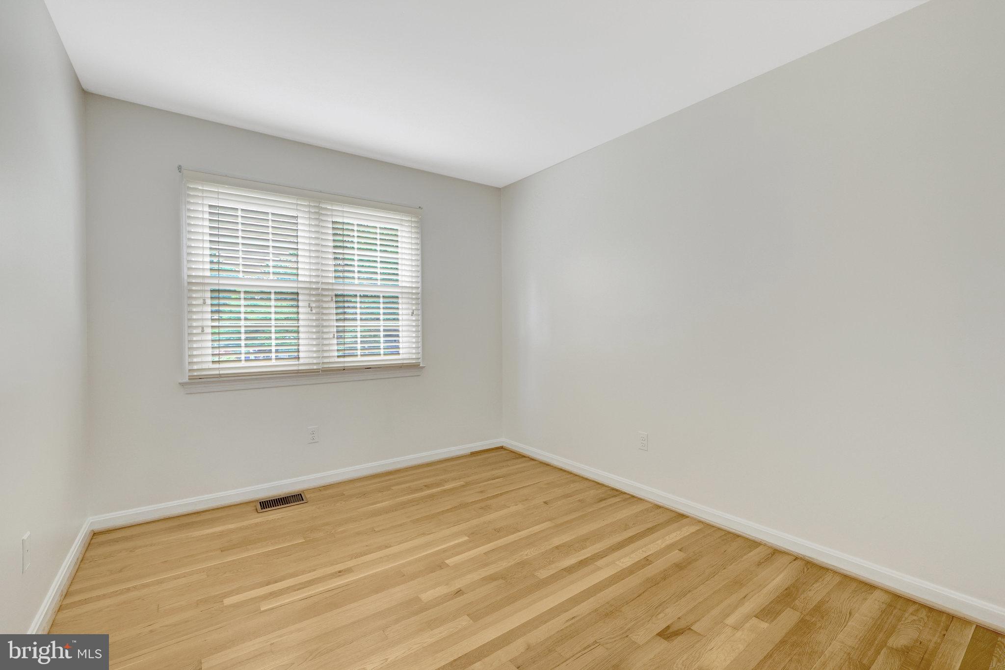 615 Kearney Court Southwest Vienna, VA 22180 - Photo 22 of 53 a view of an empty room with wooden floor and a window