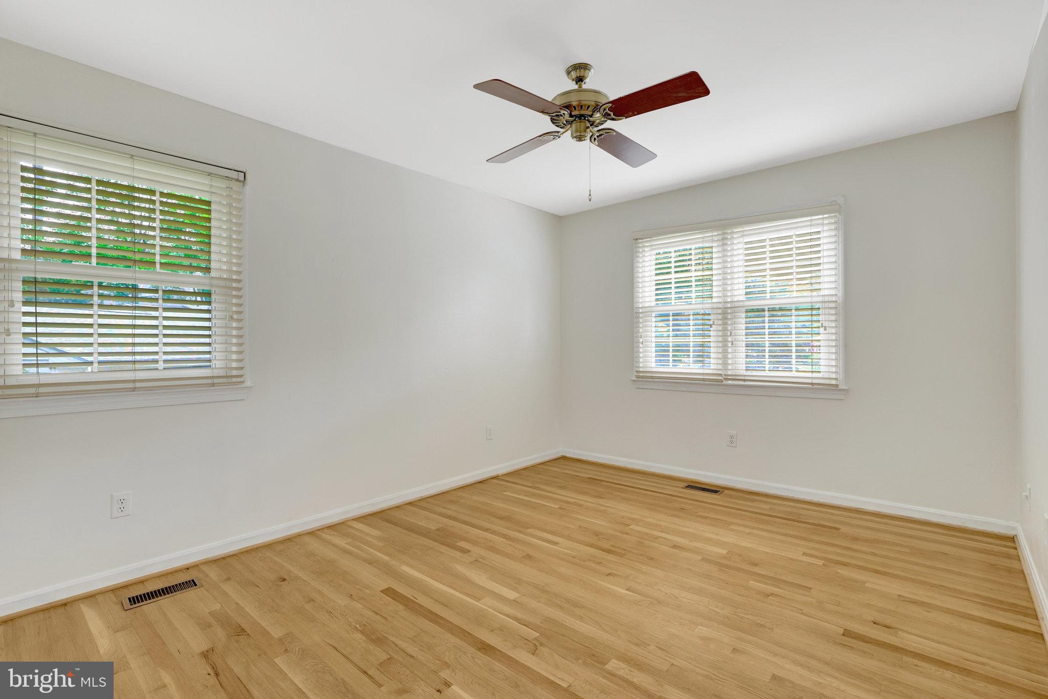 615 Kearney Court Southwest Vienna, VA 22180 - Photo 24 of 53 a view of a big room with wooden floor a ceiling fan and windows