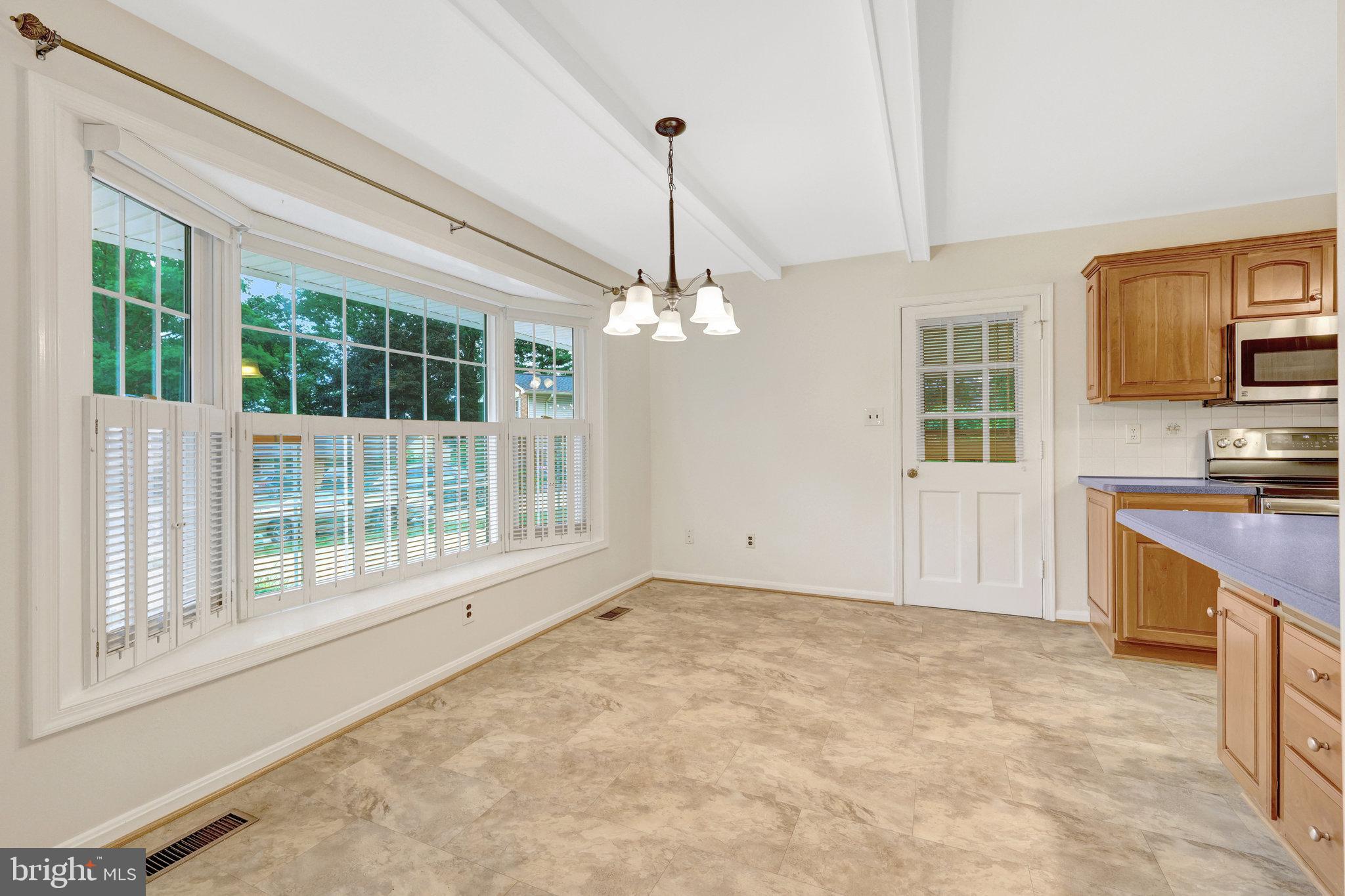 615 Kearney Court Southwest Vienna, VA 22180 - Photo 8 of 53 a view of a kitchen with a stove cabinets and a floor to ceiling window