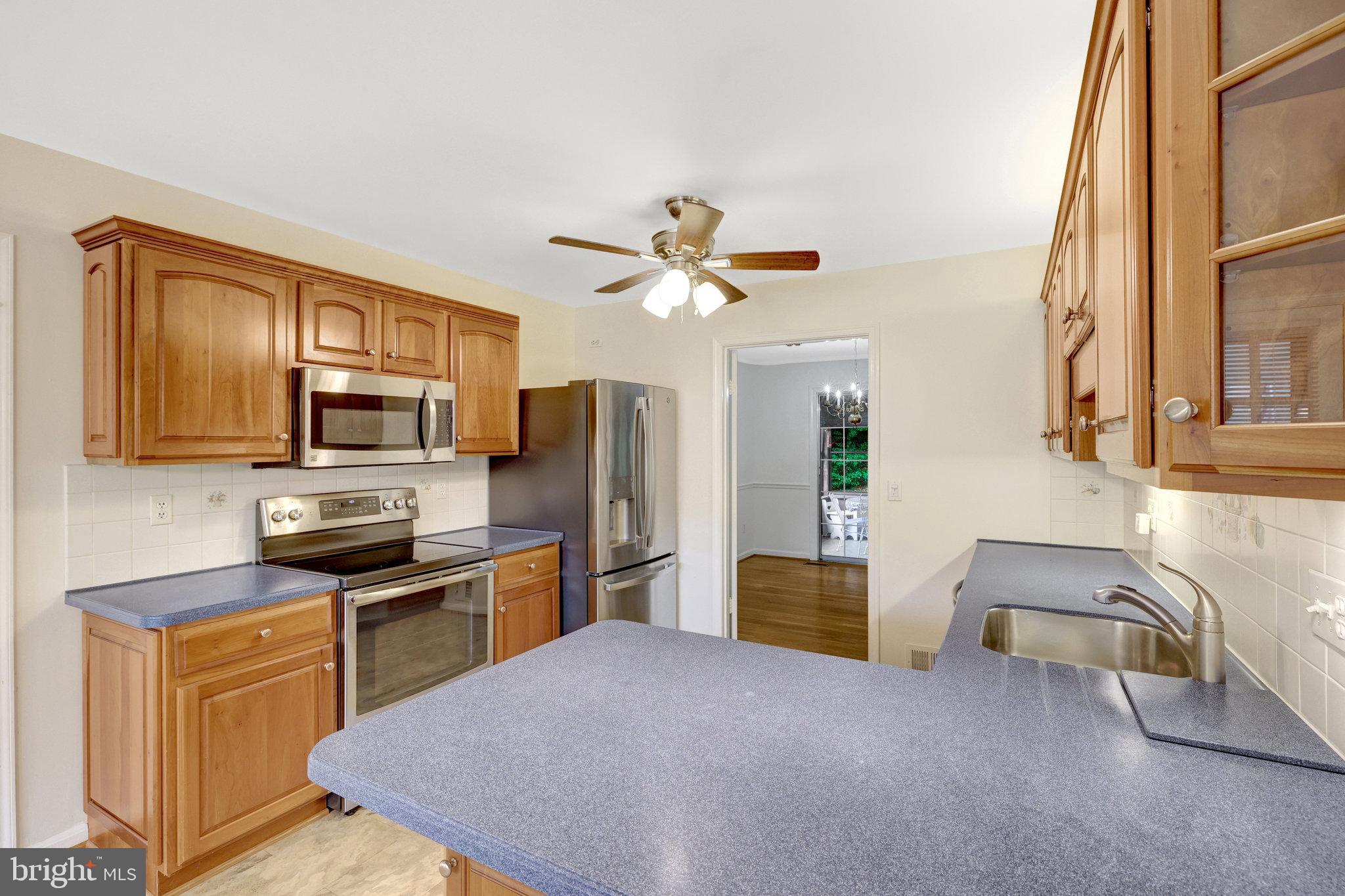 615 Kearney Court Southwest Vienna, VA 22180 - Photo 10 of 53 a kitchen with stainless steel appliances granite countertop a refrigerator stove microwave and sink