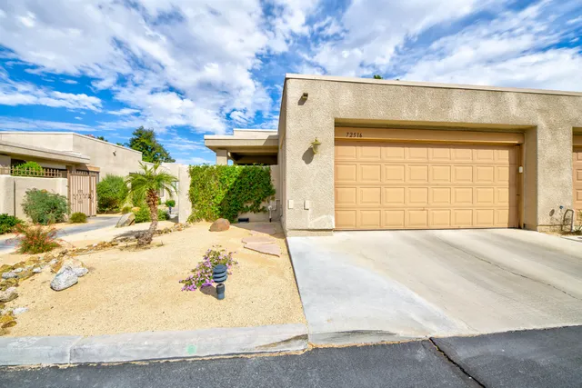 a view of a house with a yard and garage