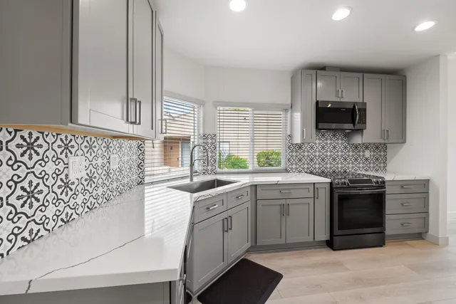 a kitchen with a sink stove and microwave