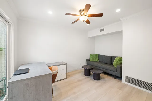 a living room with furniture and a ceiling fan