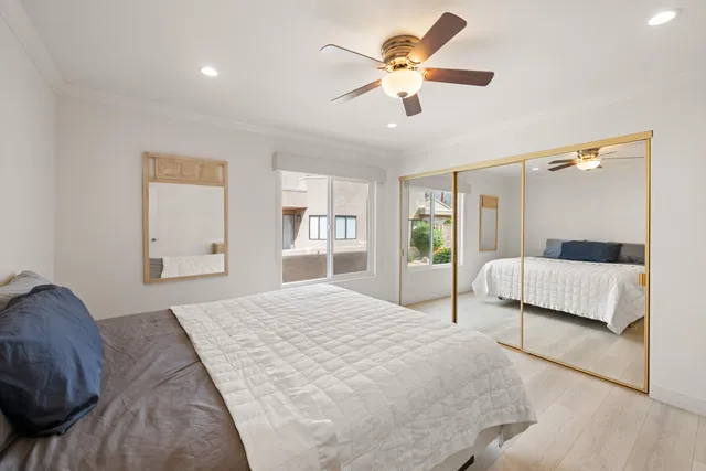 a bedroom with a large bed and a chandelier