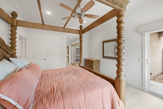 a bedroom with a bed and a mirror