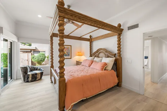 a bedroom with a bed couch and a window