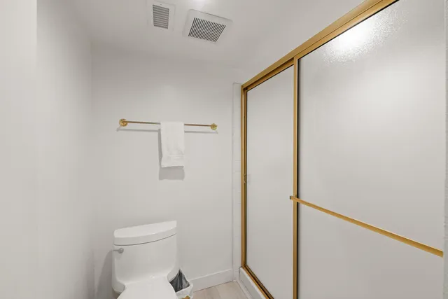 a bathroom with a toilet and shower