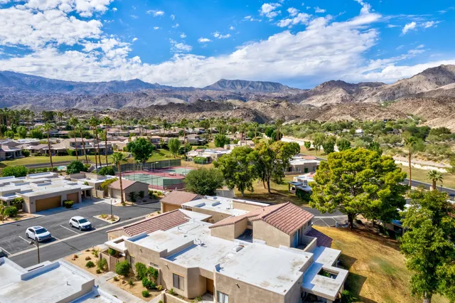 an aerial view of residential houses with outdoor space