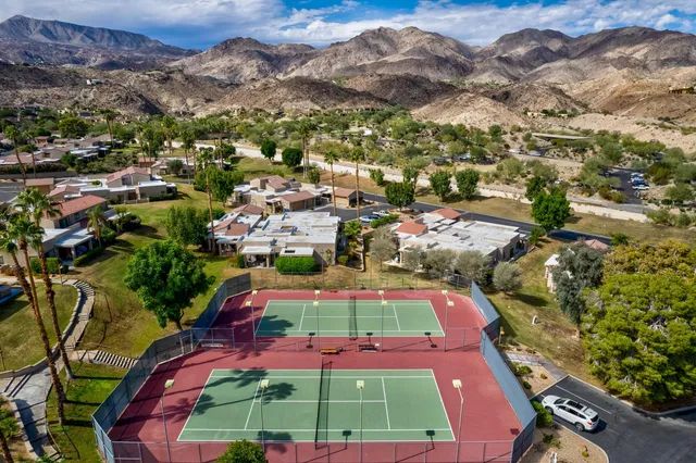 an aerial view of residential houses with outdoor space