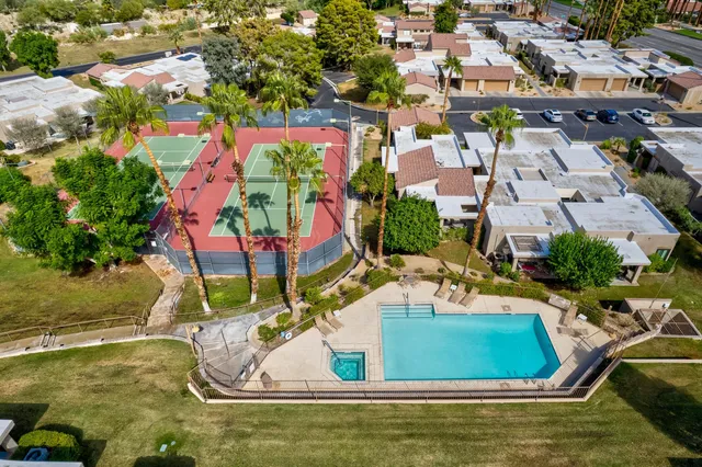 an aerial view of residential houses with yard