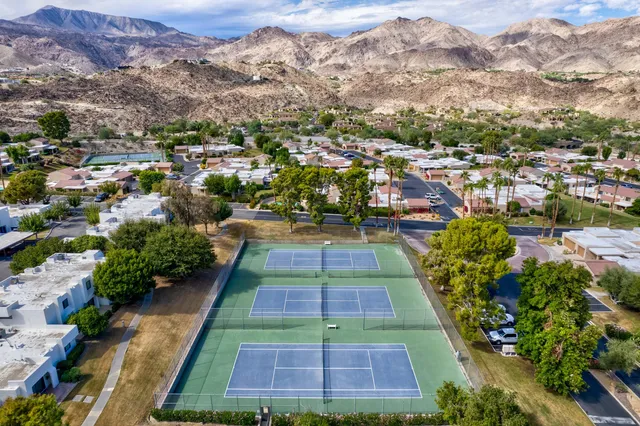 a aerial view of a house with a yard and potted plants