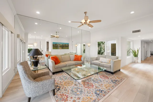a living room with furniture and a chandelier