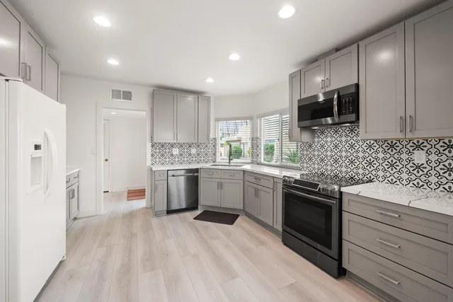 a kitchen with a sink stove and refrigerator