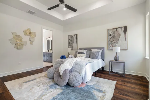 a bed room with a bed and a painting on the wall