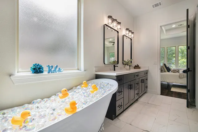 a bathroom with a tub sink and mirror