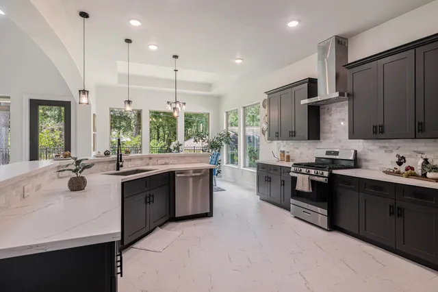 a kitchen with stainless steel appliances a stove sink and microwave