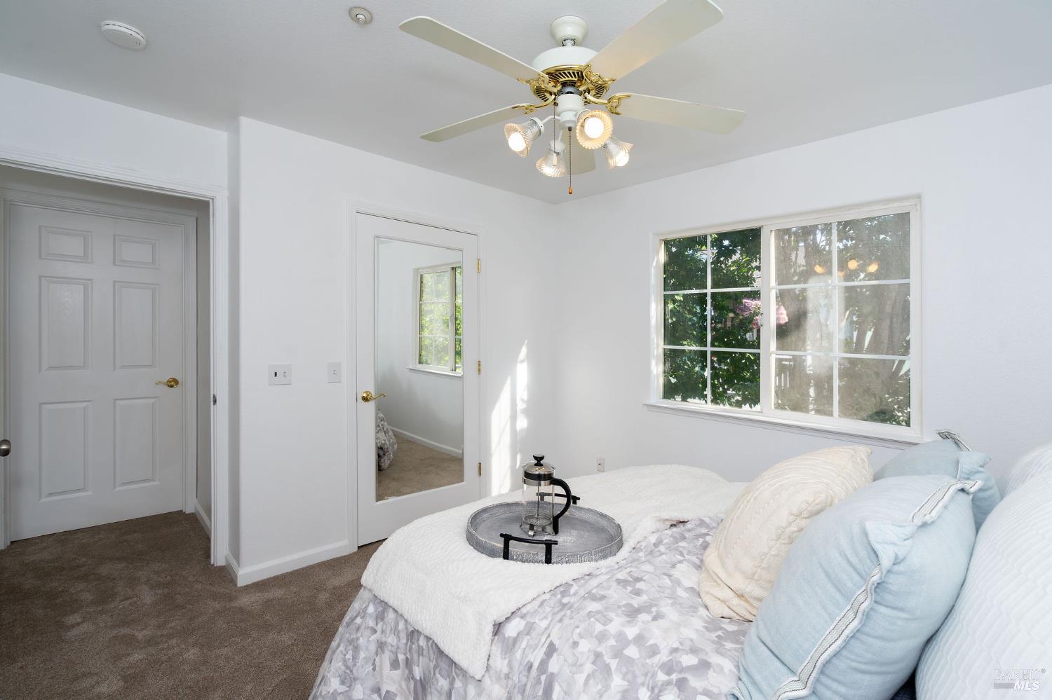 1501 La Esplanada Place, Unit 326 Santa Rosa, CA 95404 - Photo 9 of 10 a bedroom with a bed chandelier and window