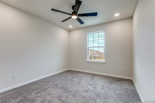 a view of a livingroom with a ceiling fan and window