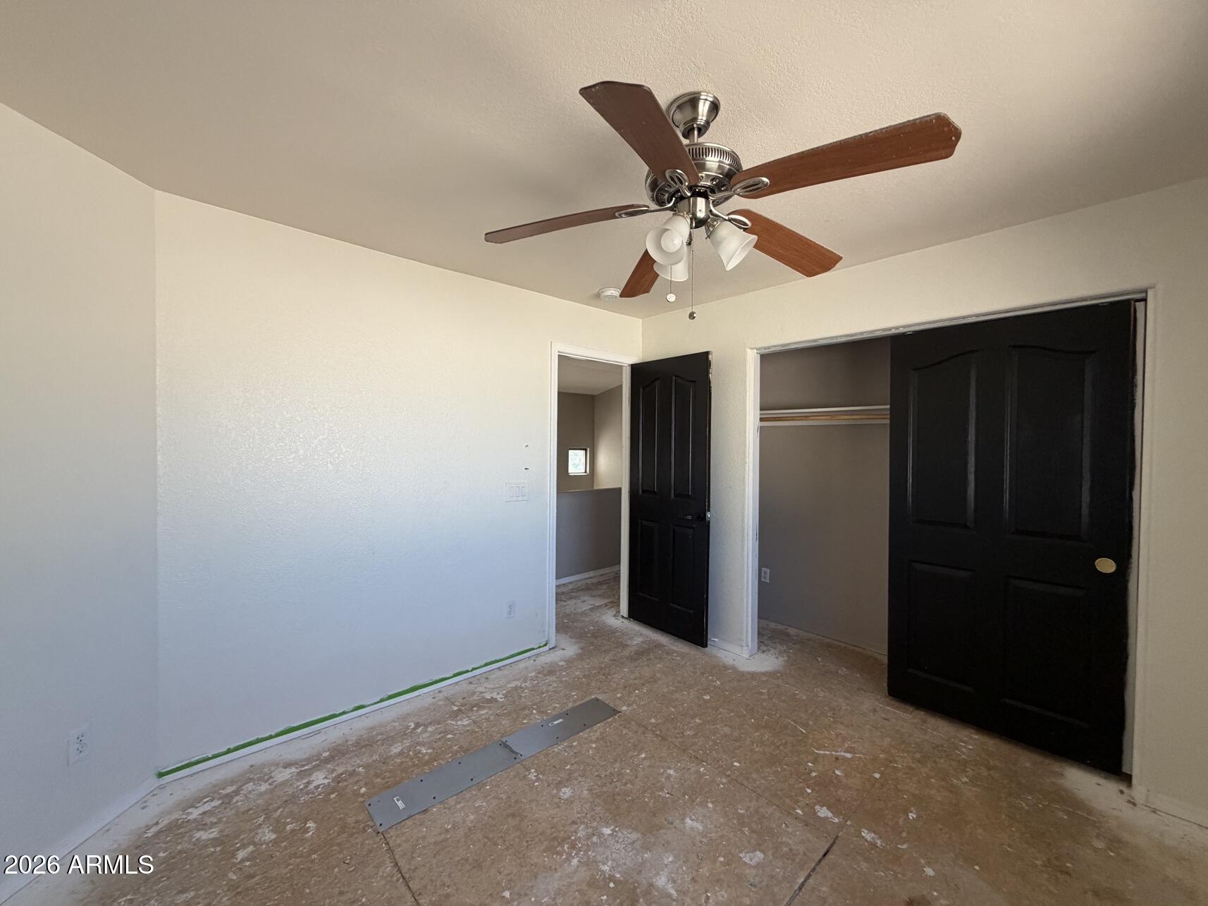 10807 West Monte Vista Road Avondale, AZ 85392 - Photo 21 of 33 an empty room with closet and a chandelier fan