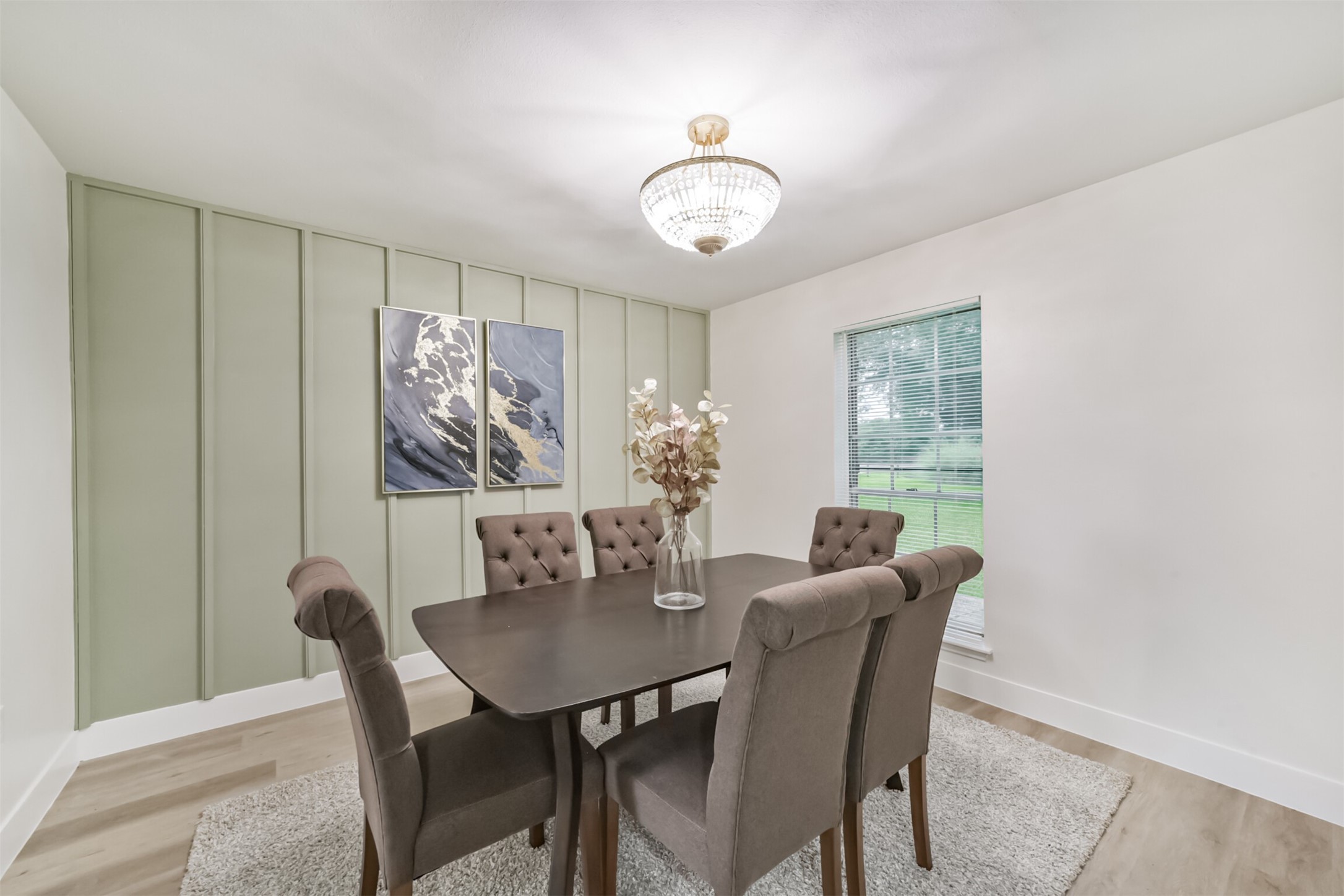 5403 Croix Road Manvel, TX 77578 - Photo 17 of 25 Elegant formal dining room with accent wall detailing and large window views that create a warm and inviting space.