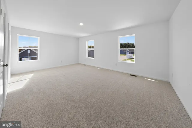 an empty room with a empty space and windows