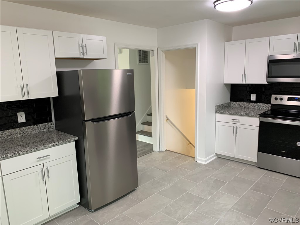 1616 Westbrook Road Hopewell, VA 23860 - Photo 6 of 24 a kitchen with a refrigerator sink and cabinets