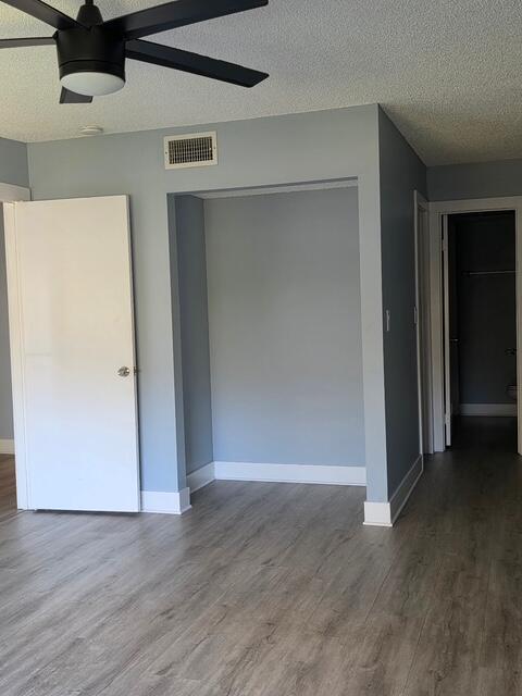 9440 Southwest 8th Street, Unit 417 Boca Raton, FL 33428 - Photo 12 of 21 an empty room with wooden floor & closet