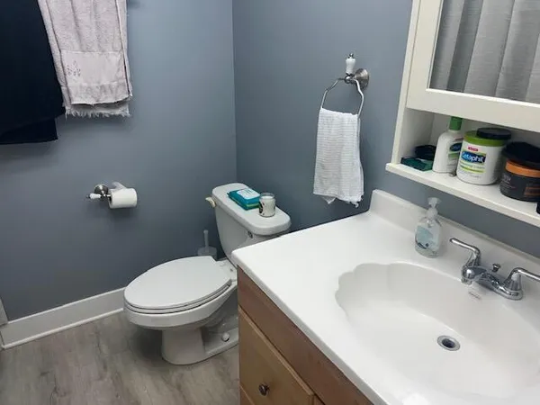 a white toilet sitting next to a bathroom sink