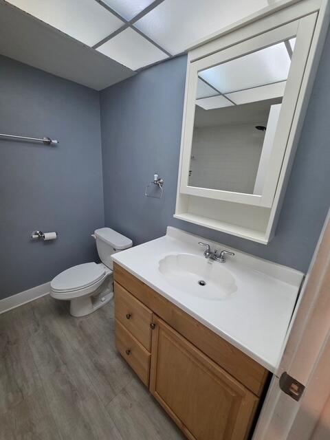9440 Southwest 8th Street, Unit 417 Boca Raton, FL 33428 - Photo 14 of 21 a bathroom with a toilet a sink and mirror
