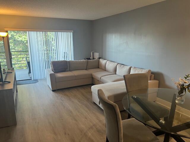 9440 Southwest 8th Street, Unit 417 Boca Raton, FL 33428 - Photo 2 of 21 a living room with furniture and a large window