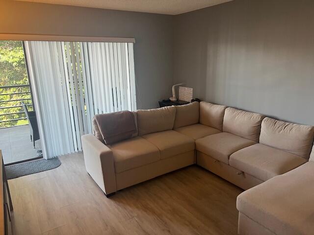 9440 Southwest 8th Street, Unit 417 Boca Raton, FL 33428 - Photo 3 of 21 a living room with furniture and a window